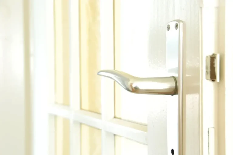 How to change a uPVC door lock in Hastings – white door with a lever handle on a long backplate, Locksmith Hastings guide to barrel, handle and multipoint replacement