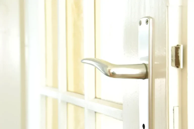 Lock repair or replacement in Hastings – white door with a lever handle and locking plate, Locksmith Hastings guide to which your door needs