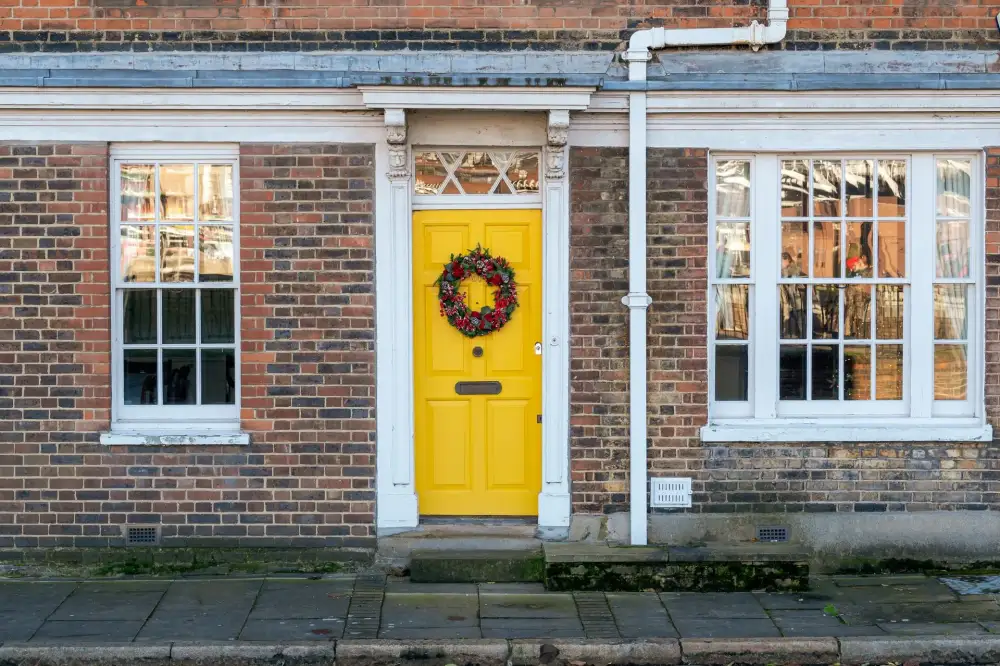 Yellow front door on a red-brick Victorian house – residential locksmith Hastings front door security check by Locksmith Hastings